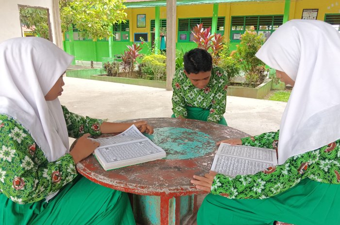 Murid MTsN 4 Batang Hari Manfaatkan Waktu Luang dengan Membaca Al-Quran di Pendopo Madrasah